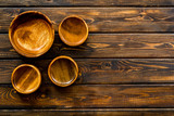 Making wooden dishes. Empty bowls on dark wooden background top view copy space