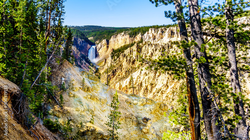 The Upper Falls of the Yellowstone River as the river flows through the yellow and orange sandstone cliffs in the Grand Canyon of the Yellowstone, in Yellowstone National Park, Wyoming, USA