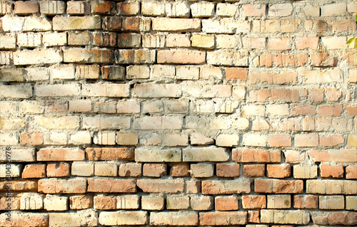 ancient red brick wall texture grunge background with hard shadows in sunlight, can use for interior design.