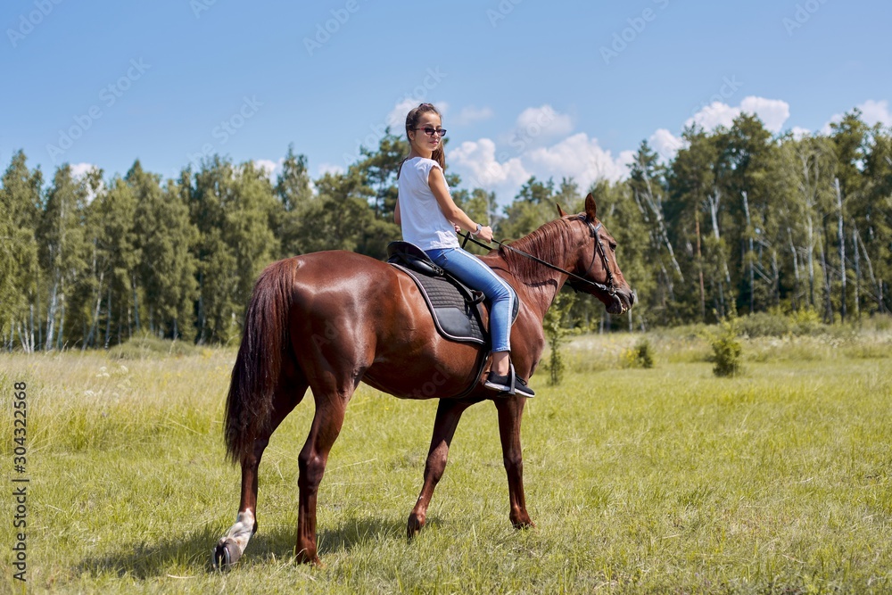 Teenager girl riding a brown horse, horseback riding for people in the park Teenager girl riding a brown horse, horseback riding for people in the park