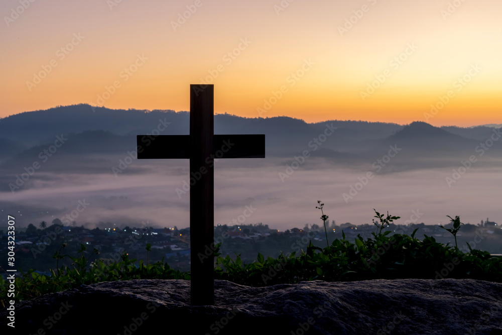 cross crucifixion of the crucifixion of jesus christ on a mountain with a morning sky background