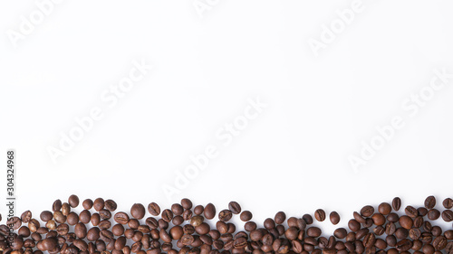 Arrangement of coffee beans on white with space for copy