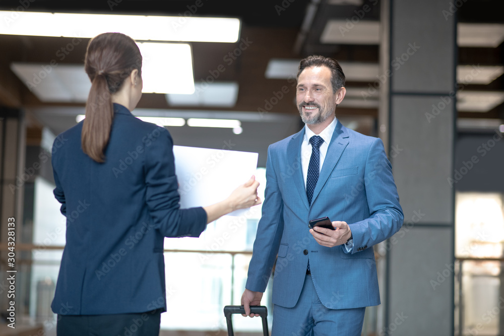 Smiling businessman feeling excited while meeting his business partner Smiling businessman feeling excited while meeting his business partner
