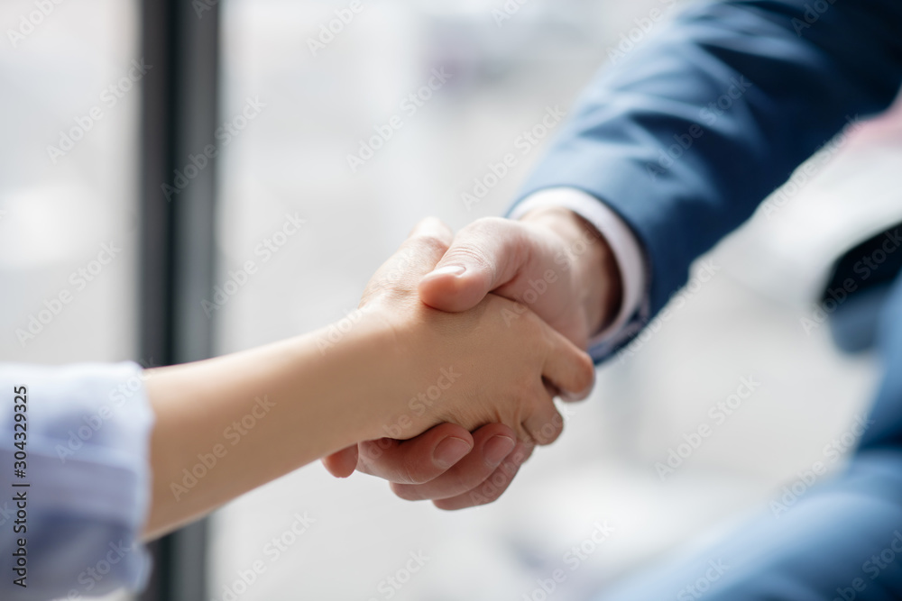 Businessman shaking hand of his assistant after help and assistance