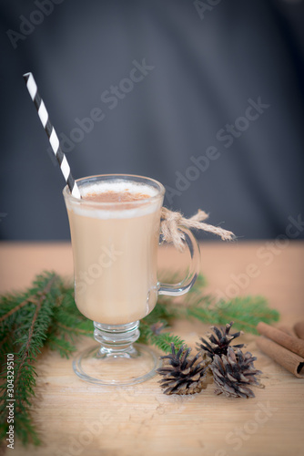 Chocolate Martini Cocktail or eggnog with cinnamon and chocolate in glass for Christmas on mahogany background. Homemade festive cocktail for winter holidays.Close up.
