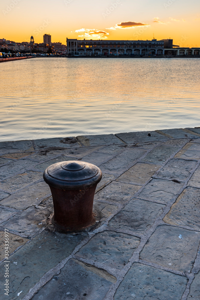 Naklejka premium Sunset from the Audace pier of Trieste. Colors of fire on the water. Italy