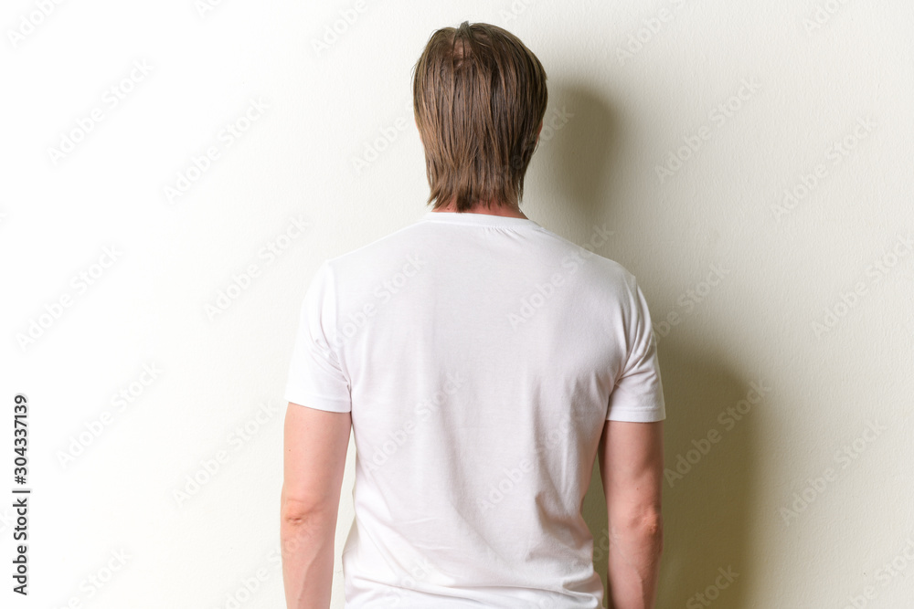 Rear view of young man with long blond hair Rear view of young man with long blond hair