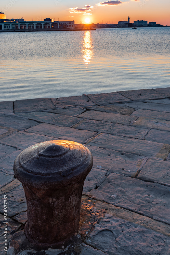 Sunset from the Audace pier of Trieste. Colors of fire on the water. Italy Sunset from the Audace pier of Trieste. Colors of fire on the water. Italy