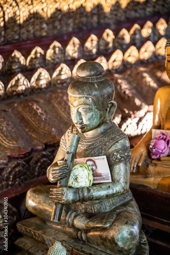  Buddha statue inside Wat Phnom, Phnom Penh, Cambodia