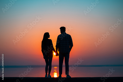 The couple against the beautiful sunset