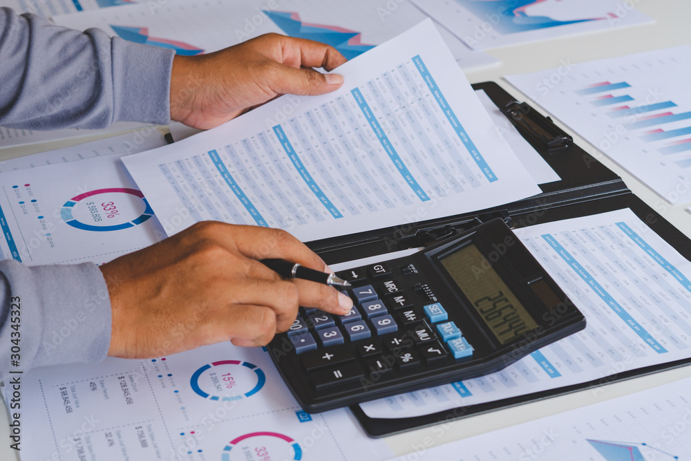 businessman working calculate data document graph chart report marketing research development planning management strategy analysis financial accounting. Business office concept. businessman working calculate data document graph chart report marketing research development planning management strategy analysis financial accounting. Business office concept.