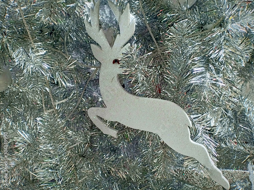 Reindeer on a background of Christmas pine branches. photo