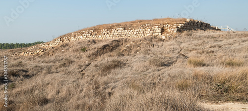 ruins of the ancient city of Lakhish royal palace foundation sits on the highest point and covers three acres as viewed from the main road of Tel Lachish in Israel photo