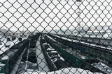 mesh netting protects people on the bridge over the railway from falling onto the train and wagons below on a winter snowy day