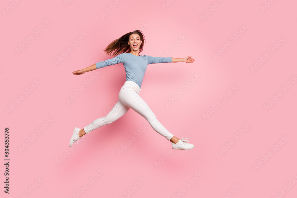 Full length body size photo of cheerful side profile crazy running jumping girlfriend expressing emotions on face isolated pastel color backgrond Full length body size photo of cheerful side profile crazy running jumping girlfriend expressing emotions on face isolated pastel color backgrond