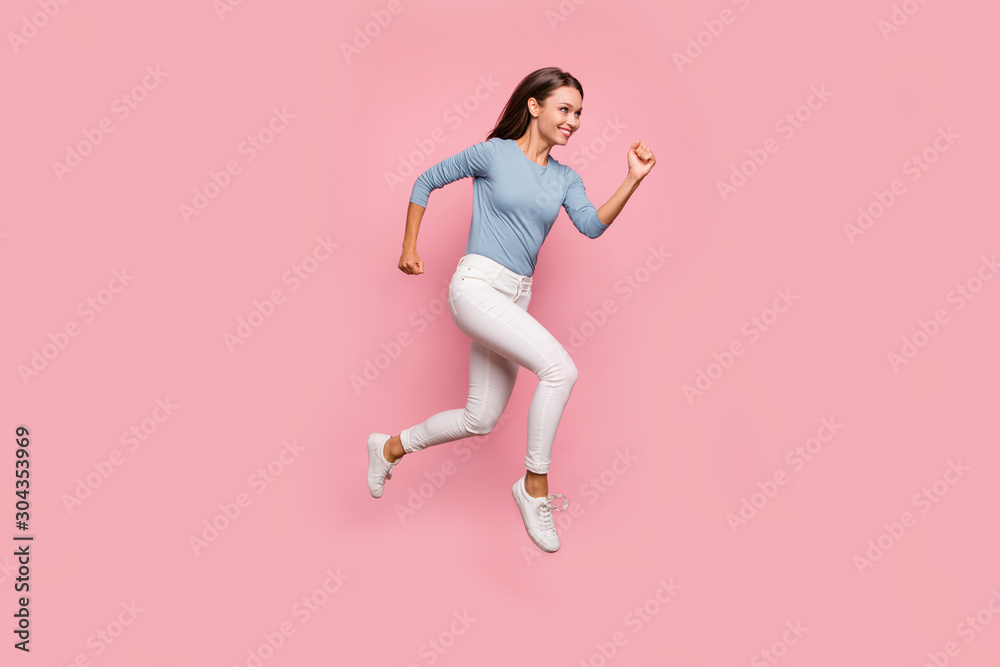Turned full length body size photo of cheerful positive cute nice pretty girl jumping running in white footwear smiling toothily isolated pastel color background