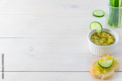 Cucumber jam with lemon on a wooden table. Horizontal orientation, copy space.