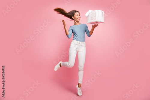 Full length body size photo of cheerful positive cute pretty nice girlfriend throwing box and hair in white sneakers isolated pastel color background