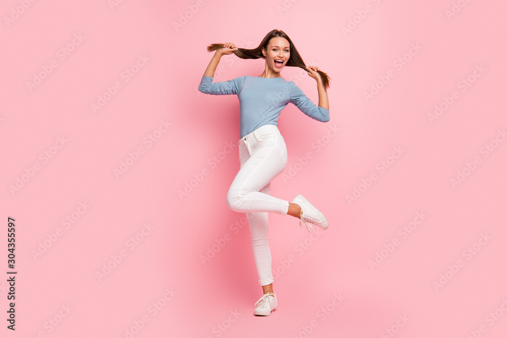 Full length body size photo of cheerful positive cute pretty girl showing her healthy hair jumping dancing isolated pastel color background