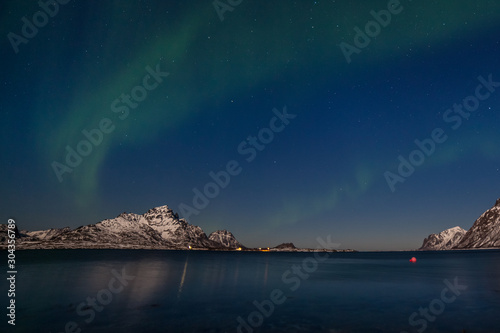 Amazing northern lights, Aurora borealis over the mountains in the North of Europe - Lofoten islands, Norway © Tatiana