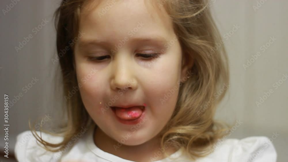 Child mouth bites rose donut. Closeup baby girl eating doughnut with glase. Delicious, sweet, sweettooth Child mouth bites rose donut. Closeup baby girl eating doughnut with glase. Delicious, sweet, sweettooth