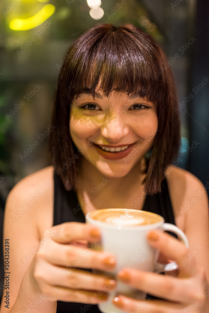Beautiful young girl drinks coffee at cafe Beautiful young girl drinks coffee at cafe