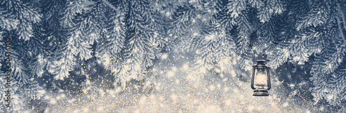 Fir tree covered snow and rime, lantern closeup. Christmas panoramic background with sparkles. Holiday spruce branches panorama, falling snowflakes. Nature winter mixed media art. Soft vintage toned
