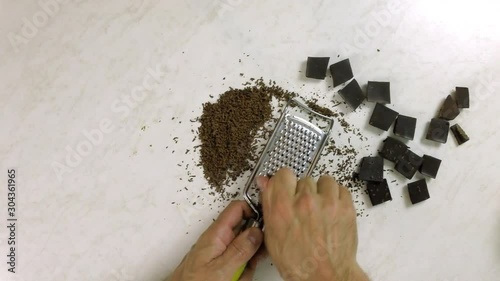 Grating Chocolate Using Handheld Grater photo