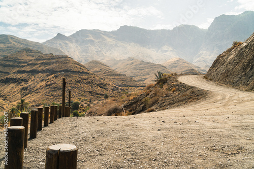 Road above black beach Playa de Guayedra in Las Palmas on Gran Canaria volcanic island, Spain, Atlantic ocean, rocky road, rural, parking, photo