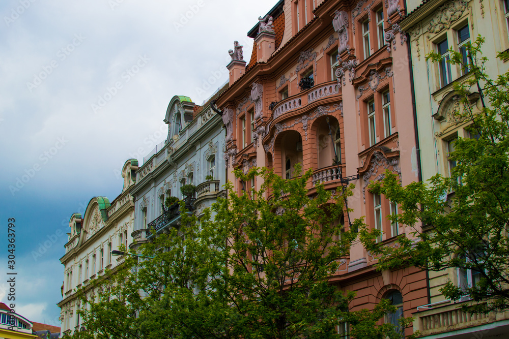 Naklejka premium Facade of a typical colorful classic building in a street in middle of Prague, Czech Republic