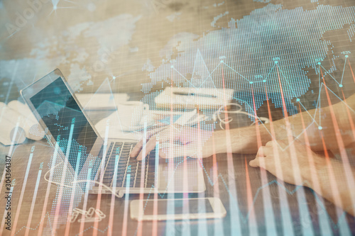 Double exposure of forex chart with man working on computer on background. Concept of market analysis.