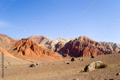 Martian landscape on earth. Mars on earth. Red rocks and a lifeless desert under the blue sky. Kyrgyzstan