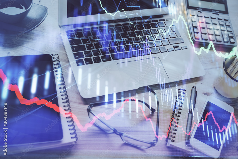 Forex market chart hologram and personal computer background. Double exposure. Concept of investment. Forex market chart hologram and personal computer background. Double exposure. Concept of investment.