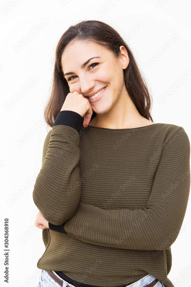 Happy beautiful Latin woman touching face, posing for camera, smiling. Young woman in casual standing isolated over white background. Female portrait concept Happy beautiful Latin woman touching face, posing for camera, smiling. Young woman in casual standing isolated over white background. Female portrait concept