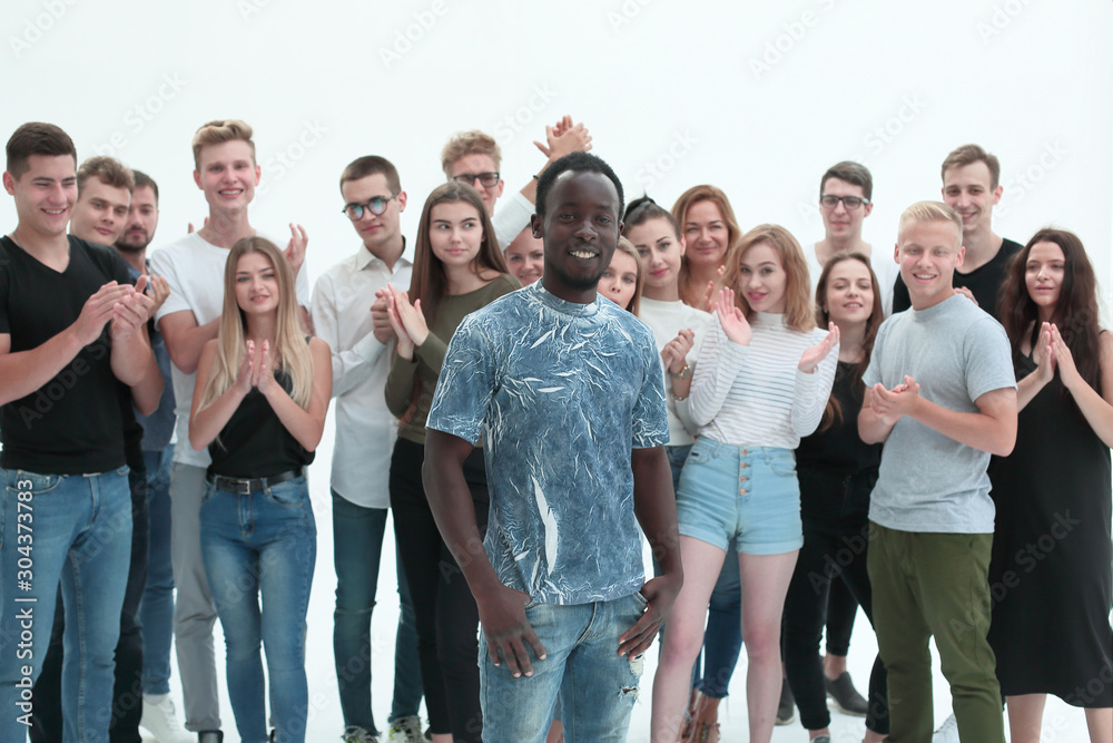 handsome guy standing in front of a large group of young people.