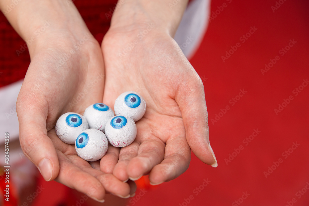 Many eyeballs with blue iris in the palms of the girl. Concept for halloween texture. Many eyeballs with blue iris in the palms of the girl. Concept for halloween texture.