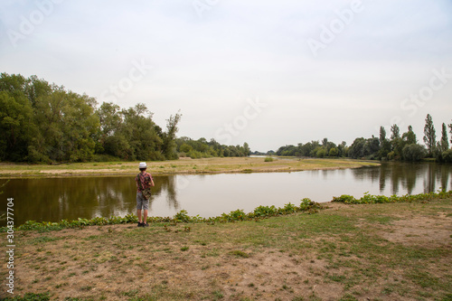 Boy looking at the river in the village of Apremont sur Allier in the region of Cher, designated a Les Plus Beaux Village or A Most Beautiful Village of France photo