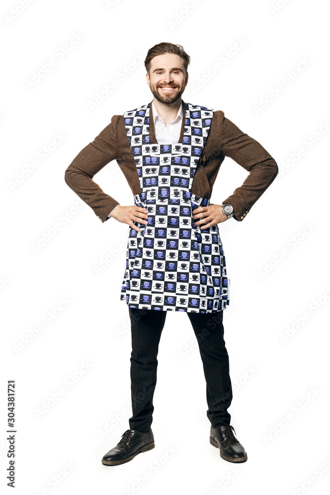 Young attractive man in a businessman suit and home apron for cleaning, smiles put his hands on his hips. Isolated on a white background. Young attractive man in a businessman suit and home apron for cleaning, smiles put his hands on his hips. Isolated on a white background.