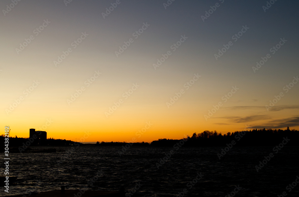 Fototapeta premium Sunset over the sea at Rauma Harbour, Finland on a clear evening