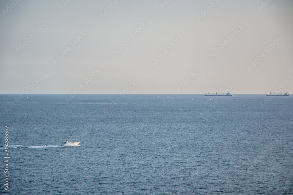Beautiful peaceful waters, Black sea, blue sky and calm water, ships and yachts in the sea