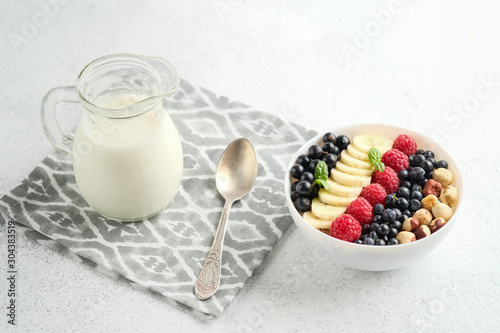 .Oatmeal with berries and fruits on a light background. Healthy breakfast.