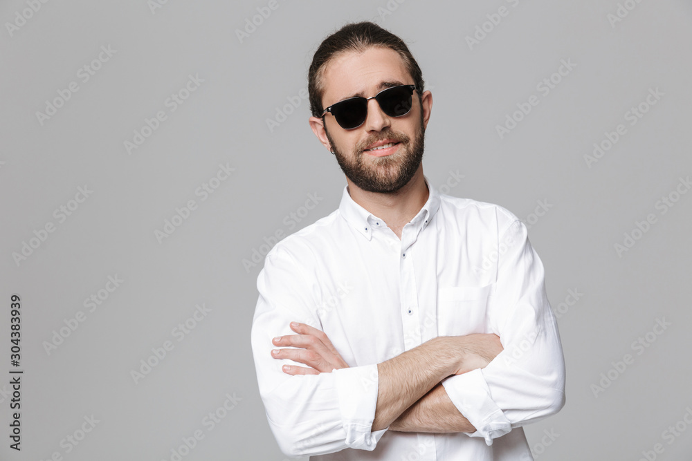 Bearded man posing isolated wearing sunglasses.