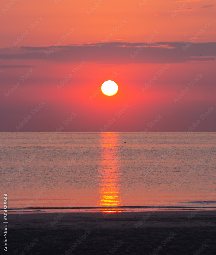 peaceful ocean sunrise with calm sea at Rivazzurra (Rimini/Italy) beach