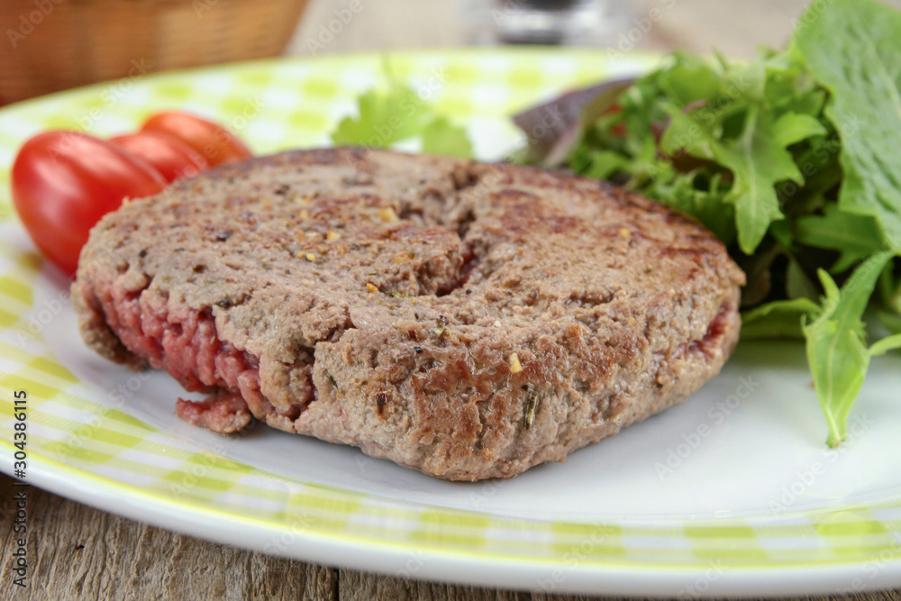 grilled ground beef steak and salad on a plate grilled ground beef steak and salad on a plate