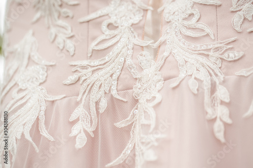 bridesmaid dress lace. ace oneself up corset on white wedding dress, close up