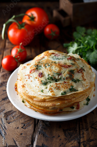 Savory crepes or pancakes with tomato and spinach