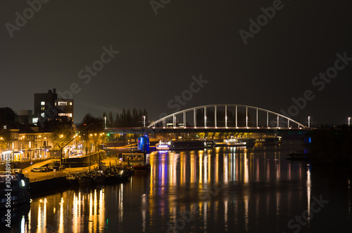 Arnhem in the Netherlands, with the John Frost bridge at night with in the foreground the river Rhine