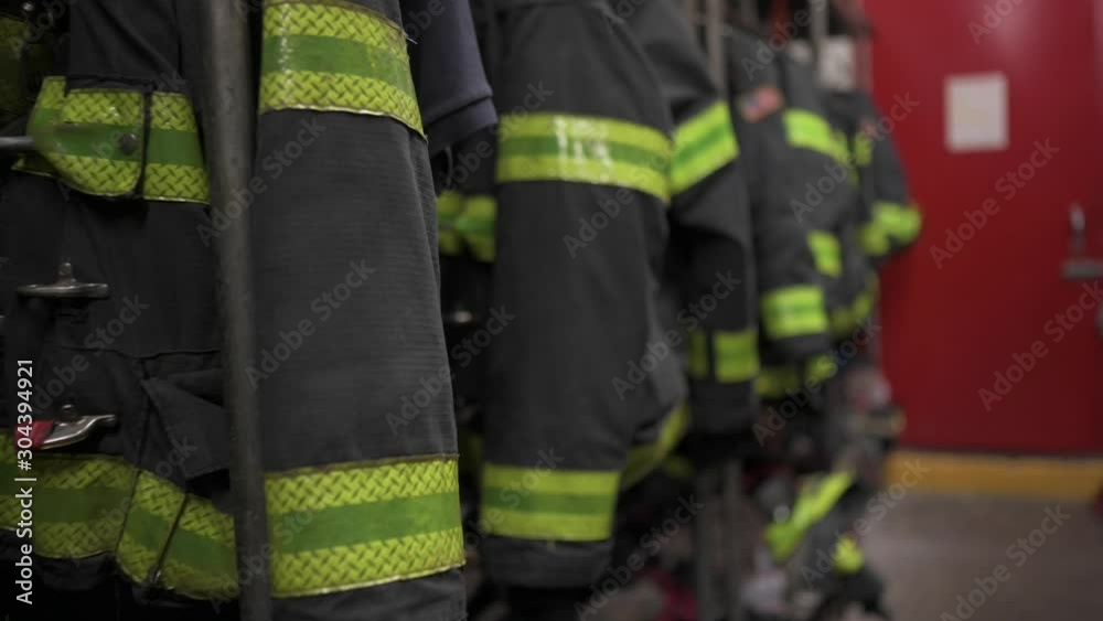 Firefighters' uniforms inside a firehouse Firefighters' uniforms inside a firehouse