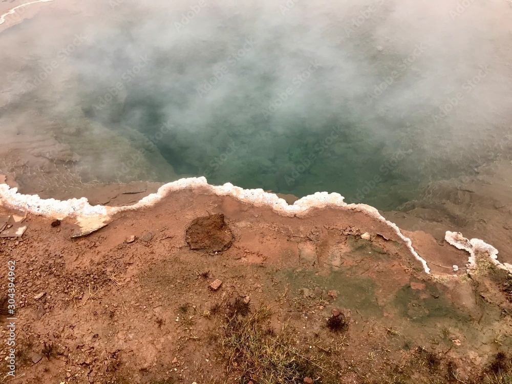 The Konungshver Geyser, part of Haukadalur, the home of geysers and other geothermal features along the Golden Circle tourist route in southern Iceland on a foggy autumn afternoon