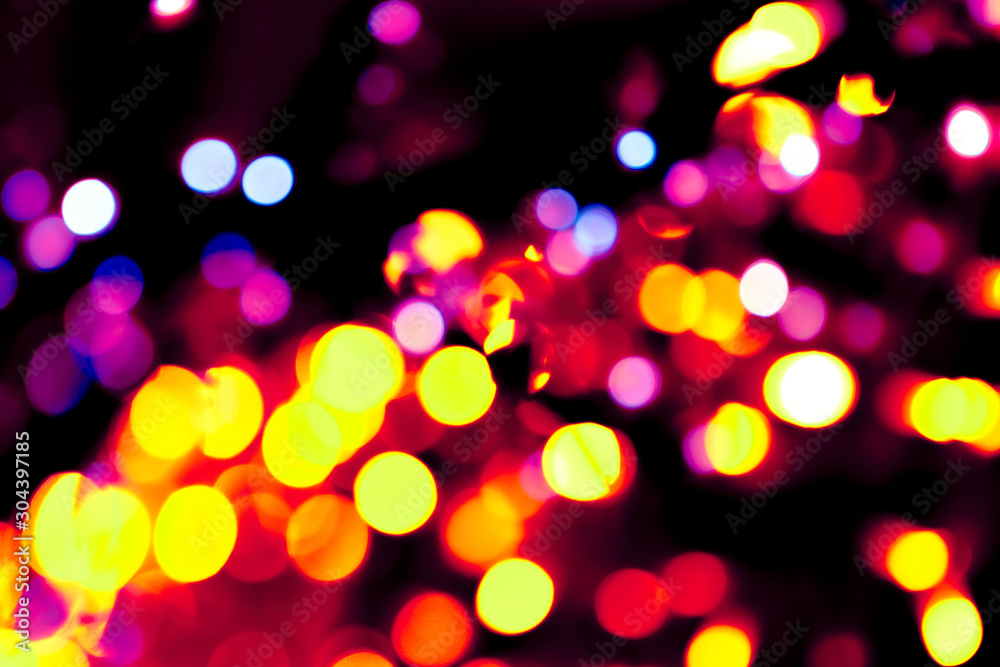 Colorful circles bokeh festive glitter dark background. Holiday greeting cards, invitations, flyers, blog posts, banners design. Christmas lights bokeh overlay.	